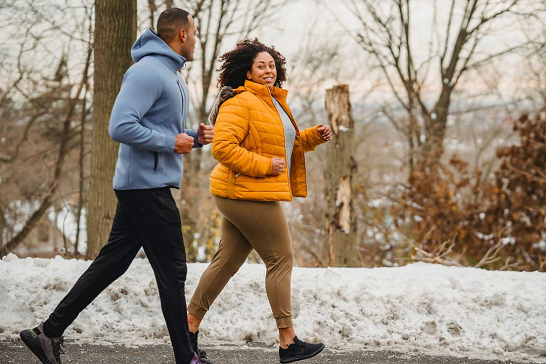 man and women running through the park together