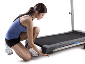 Girl adjusting incline of Weslo R 5.2